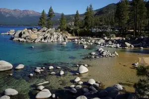 Alpine Lake at dawn — still turquoise water and granite shore